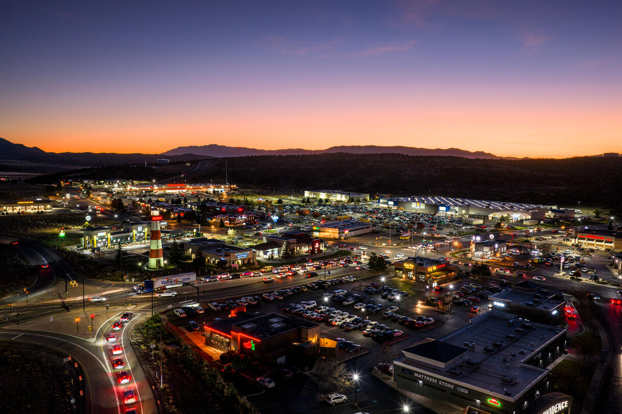 A city at dusk with a lighthouse