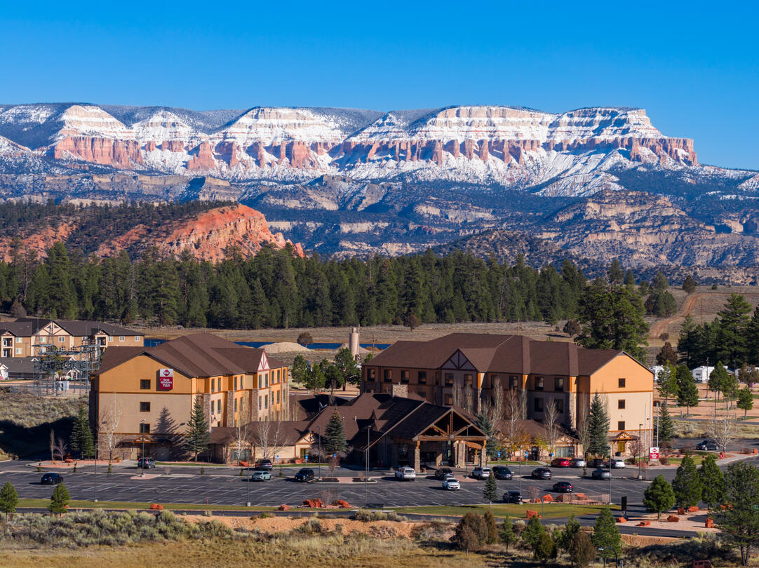 A mesa with snow behind a hotel