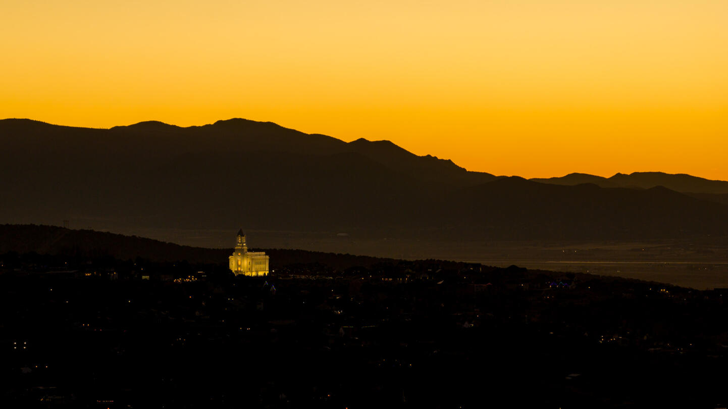 A small temple on a hill at sunset